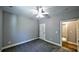Bedroom featuring carpet, neutral paint, ceiling fan and a doorway to the hall at 136 Rainey Rd, Temple, GA 30179