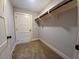 Walk-in closet featuring white shelving and rod for organization, providing ample storage space at 136 Rainey Rd, Temple, GA 30179