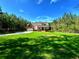 Beautifully landscaped front yard showcasing the home's exterior with an attached garage at 136 Rainey Rd, Temple, GA 30179