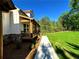 The home boasts a covered porch with stone accents, a well-manicured lawn, and green trees in the background at 136 Rainey Rd, Temple, GA 30179
