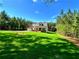 Beautifully landscaped front yard showcasing the home's exterior with an attached garage at 136 Rainey Rd, Temple, GA 30179