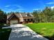 View of home's facade, featuring a well-manicured lawn, attached garage, and front porch at 136 Rainey Rd, Temple, GA 30179