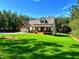 View of home's facade, featuring a well-manicured lawn, attached garage, and front porch at 136 Rainey Rd, Temple, GA 30179