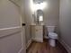 Powder room featuring modern vanity, framed mirror, and toilet at 136 Rainey Rd, Temple, GA 30179