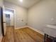 Bright laundry room featuring wood flooring, utility sink, and washer/dryer hookups at 136 Rainey Rd, Temple, GA 30179