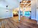 Spacious living room features hardwood floors, high ceilings, and views of the open concept kitchen and outdoor patio at 136 Rainey Rd, Temple, GA 30179