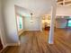 Open-concept living room with hardwood floors, an open doorway and views of the modern kitchen at 136 Rainey Rd, Temple, GA 30179