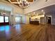 Spacious living room featuring hardwood floors, vaulted ceiling, chandelier and views to kitchen at 136 Rainey Rd, Temple, GA 30179