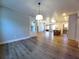 Living area featuring an open floor plan with hardwood floors, a modern kitchen, and a view of the front door at 136 Rainey Rd, Temple, GA 30179