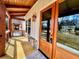 Covered front porch features stone accents, wood flooring, and provides access to the charming wood front door at 136 Rainey Rd, Temple, GA 30179