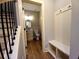Powder room with a vanity, toilet, coat hooks, and seat next to staircase at 136 Rainey Rd, Temple, GA 30179
