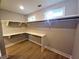 Walk-in closet featuring built-in shelving and wooden floors, providing ample storage space at 136 Rainey Rd, Temple, GA 30179
