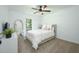 Cozy bedroom features a comfortable bed, ceiling fan, and a large mirror at 140 Pine Glade Trce, Roswell, GA 30075