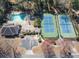 A clear aerial view of a community pool and tennis courts in a wooded residential area at 2000 Stethem Ferry Rd, Johns Creek, GA 30022
