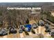 An aerial view showcases an upscale neighborhood next to the Chattahoochee River in a wooded area at 2000 Stethem Ferry Rd, Johns Creek, GA 30022