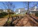 Landscaped backyard with a decorative bridge and flower pot, perfect for enjoying outdoor tranquility at 2000 Stethem Ferry Rd, Johns Creek, GA 30022
