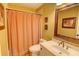 Cozy bathroom with checkered shower curtain, decorative framed art, and vanity at 2000 Stethem Ferry Rd, Johns Creek, GA 30022