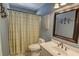 Bathroom with patterned shower curtain, framed mirror, vanity, and light blue wall at 2000 Stethem Ferry Rd, Johns Creek, GA 30022