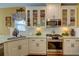 Well-lit kitchen with granite countertops, white cabinets, and a stainless steel range at 2000 Stethem Ferry Rd, Johns Creek, GA 30022