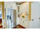 Bright kitchen area with stainless steel refrigerator, white cabinets, and granite countertops at 2000 Stethem Ferry Rd, Johns Creek, GA 30022