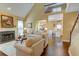 Open living room with a fireplace and access to the dining room and kitchen at 2000 Stethem Ferry Rd, Johns Creek, GA 30022
