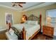 Comfortable bedroom with hardwood floors, decorative bed, and natural lighting at 2000 Stethem Ferry Rd, Johns Creek, GA 30022