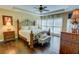 Spacious main bedroom with trey ceilings, a decorative bed, and hardwood floors at 2000 Stethem Ferry Rd, Johns Creek, GA 30022