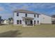 View of the backyard of a two-story home featuring a covered patio and a well-maintained lawn at 238 Arnewood Cir, Mcdonough, GA 30253