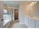 Bright bathroom featuring a soaking tub, glass-enclosed shower, and vanity with a white countertop at 238 Arnewood Cir, Mcdonough, GA 30253