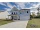 Charming two-story home featuring a manicured lawn and a two-car garage at 238 Arnewood Cir, Mcdonough, GA 30253