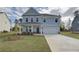 Charming two-story home featuring a manicured lawn and a two-car garage at 238 Arnewood Cir, Mcdonough, GA 30253