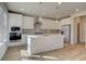Modern kitchen featuring a large island, stainless steel appliances, and pendant lighting at 238 Arnewood Cir, Mcdonough, GA 30253