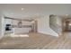 Open-concept living room with hardwood floors, white kitchen, and plenty of natural light at 238 Arnewood Cir, Mcdonough, GA 30253