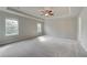 Expansive main bedroom with tray ceiling, fan, and large windows for ample natural light at 238 Arnewood Cir, Mcdonough, GA 30253