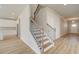 Stylish staircase featuring wood treads, metal railings, and an open floor plan at 238 Arnewood Cir, Mcdonough, GA 30253
