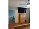 Bedroom with wood floors, dresser and TV; the ensuite bathroom is accessible through doorway at 2760 Waterford Park Dr, Lawrenceville, GA 30044