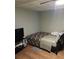 Small bedroom with ceiling fan, TV, and laminate flooring at 2760 Waterford Park Dr, Lawrenceville, GA 30044