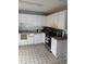 Traditional kitchen with white cabinets, black countertops, and stainless steel appliances at 2760 Waterford Park Dr, Lawrenceville, GA 30044
