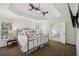 This main bedroom features a trey ceiling, ceiling fan, and an attached bathroom with a soaking tub at 7115 Doncaster Ct, Cumming, GA 30040