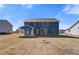 Large backyard featuring a newly built blue house with a covered patio and ample lawn space at 127 Felicity Pike, Locust Grove, GA 30248