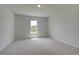 Neutral bedroom boasting ample natural light, carpet flooring, and spacious layout at 127 Felicity Pike, Locust Grove, GA 30248