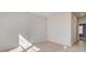 Neutral bedroom featuring light hardwood floors, white walls, and natural light at 127 Felicity Pike, Locust Grove, GA 30248
