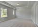 Neutral bedroom showcasing a tray ceiling and natural light at 127 Felicity Pike, Locust Grove, GA 30248