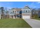 Charming two-story home featuring a brick and siding facade and a pristine front lawn at 127 Felicity Pike, Locust Grove, GA 30248