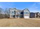 Well-designed two-story home showcasing brick accents, siding and an attached two-car garage at 127 Felicity Pike, Locust Grove, GA 30248