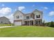 Attractive two-story home boasting a lush lawn, a two-car garage, and a blend of brick and siding at 127 Felicity Pike, Locust Grove, GA 30248