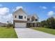 Stunning two-story home with manicured lawn, a two-car garage, and a brick and siding exterior at 127 Felicity Pike, Locust Grove, GA 30248