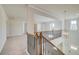 Bright hallway with carpet, chandelier, and wrought iron staircase railing and an abundance of natural light at 127 Felicity Pike, Locust Grove, GA 30248