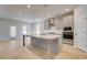Modern kitchen featuring large island, stainless appliances, and bright lighting at 127 Felicity Pike, Locust Grove, GA 30248