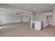 Open-concept kitchen with island, stainless steel appliances, and seamless flow to the living area at 127 Felicity Pike, Locust Grove, GA 30248